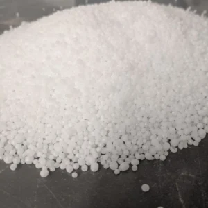 Urea granules: small white spherical pellets heaped on a dark surface