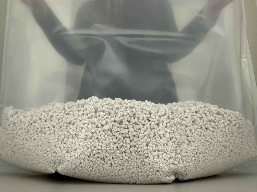 Show: An even bed of hydrated perlite spread across the base of a Cylo Grow Tent, held open from behind