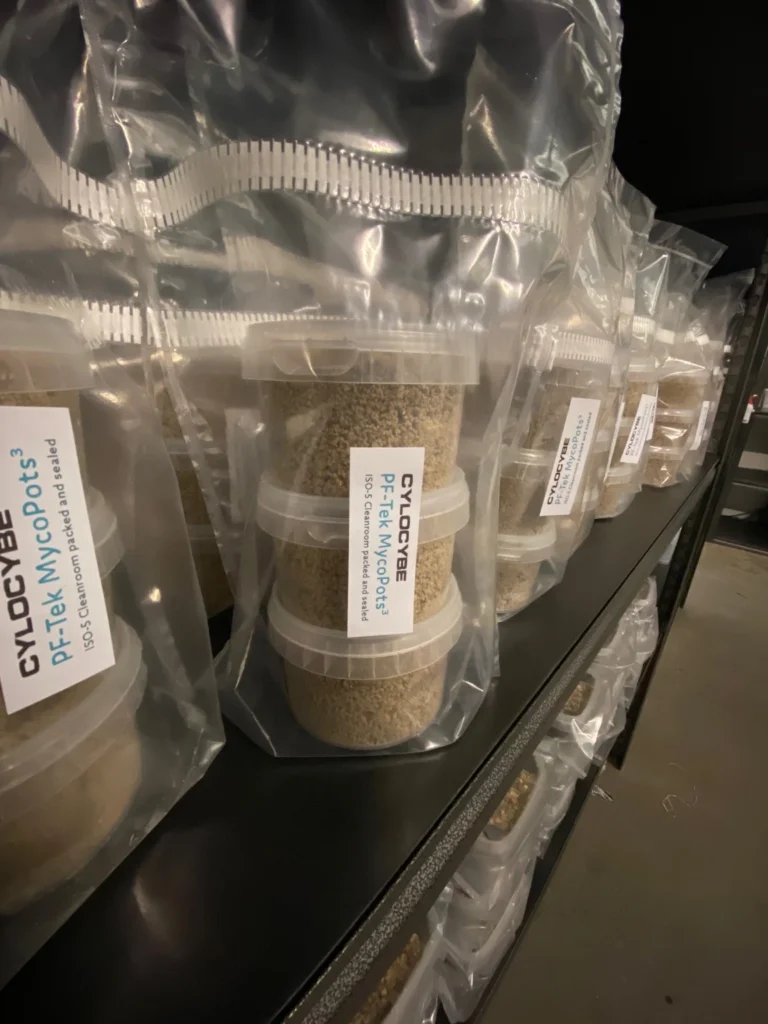 Bagged PF-Tek MycoPots grow kits on a shelf, cleanroom packed and sealed