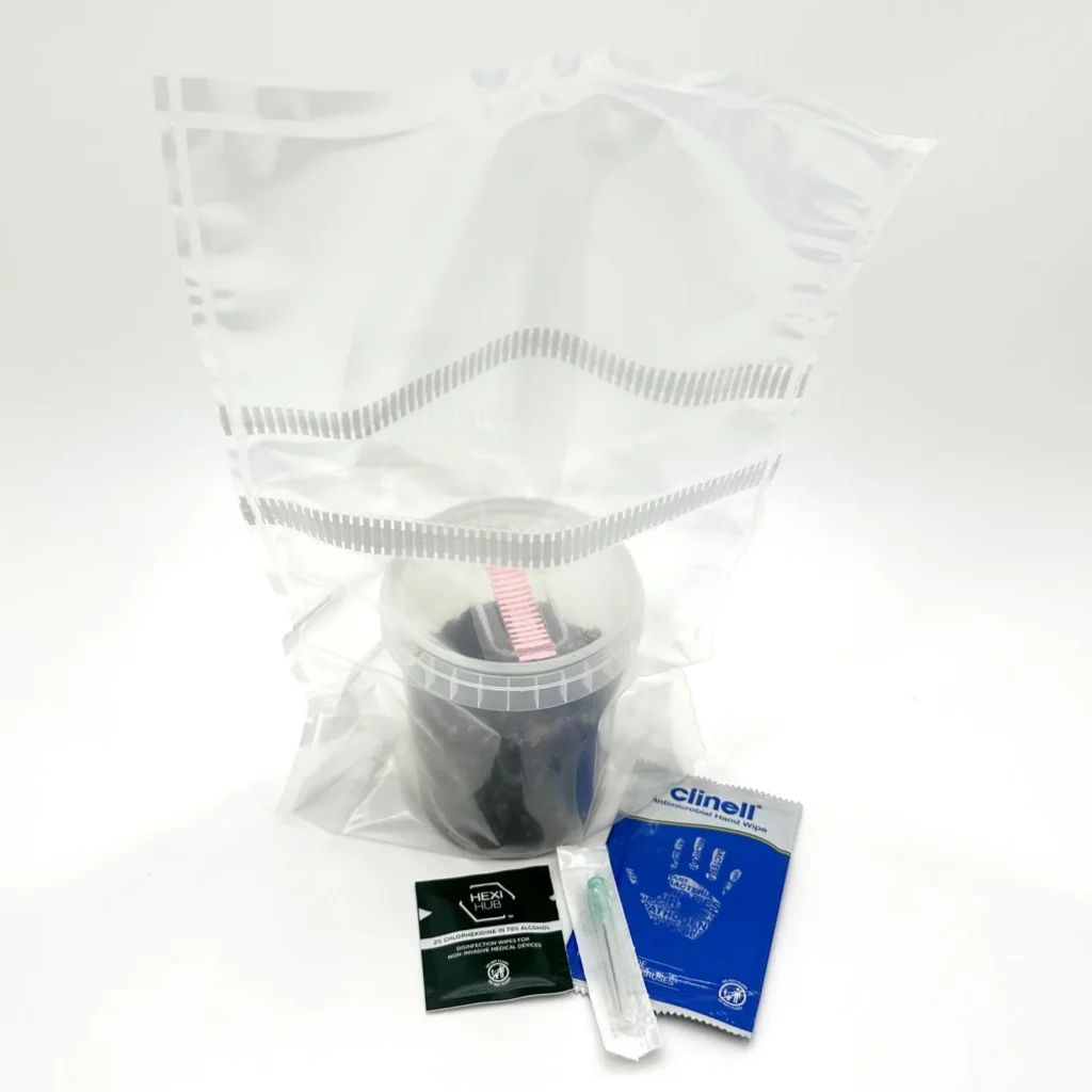 Everything in a WeeZPZ kit: a filter-patch grow bag, a sealed cup of dark substrate, a sterile needle, a chlorhexidine wipe and an antimicrobial hand wipe