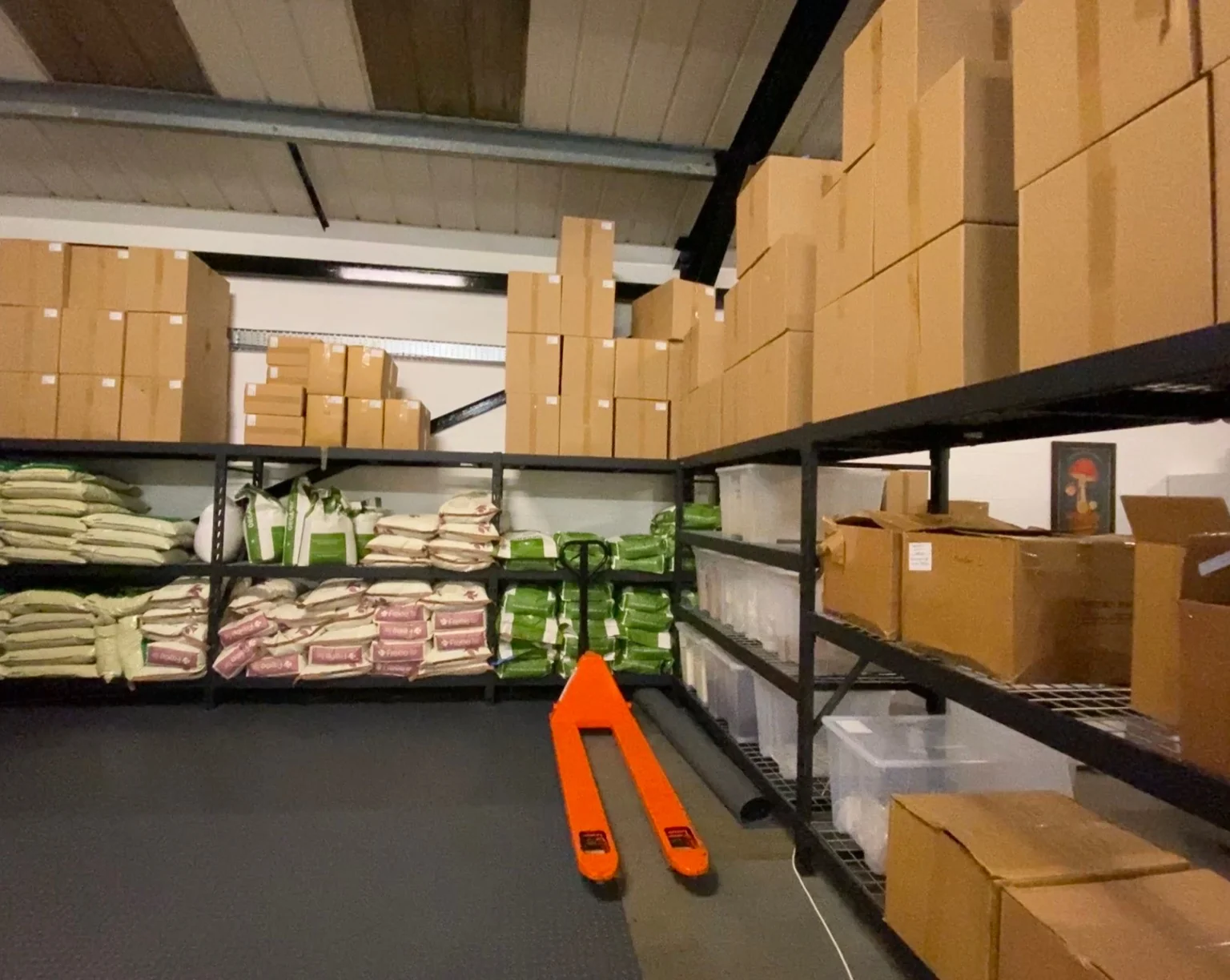 Shelves of mushroom growing supplies stocked in the Cylocybe unit